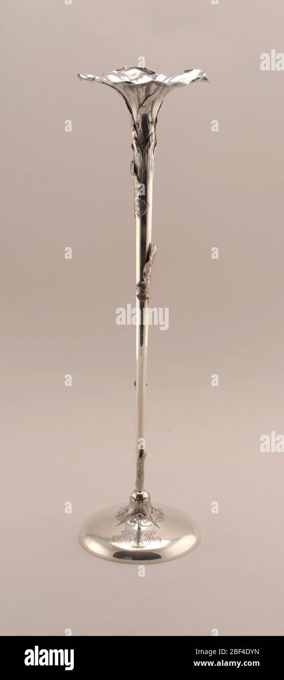 Vase. Tall thin stem with applied foliage, opening as a flowerhead, on