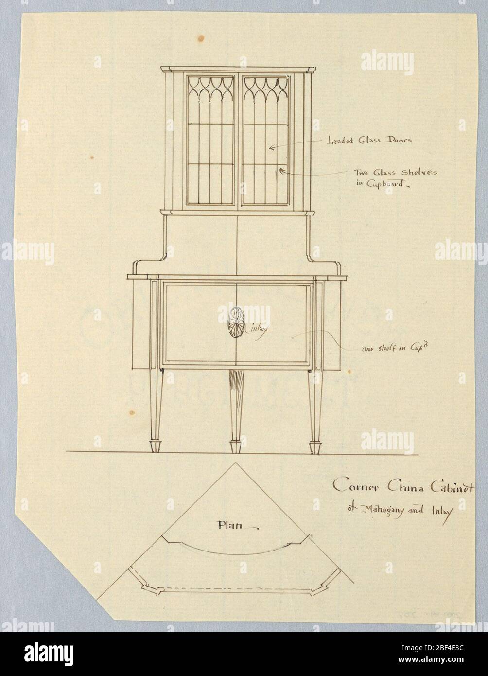 Design for Corner Cabinet in Mahogany and Inlay Plan and Elevation. Elevation: tall cabinet raised on 3 straight tapering legs; closed cupboard with inlaid patera medallion topped by tall cupboard with glass doors. Plan: triangular shape of cabinet shown; slightly slanted corners. Stock Photo
