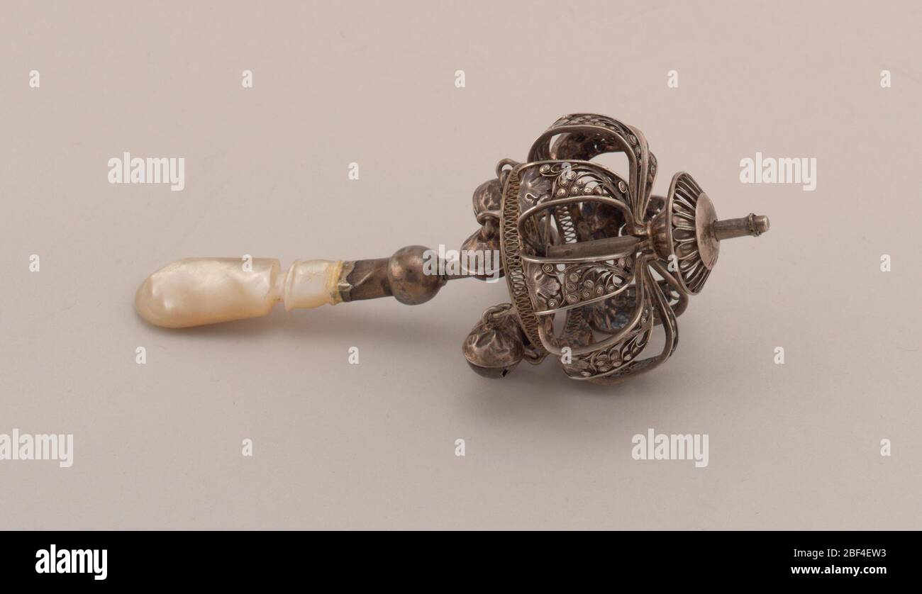 Rattle. Open cage formed of eight silver filigree straps featuring ...