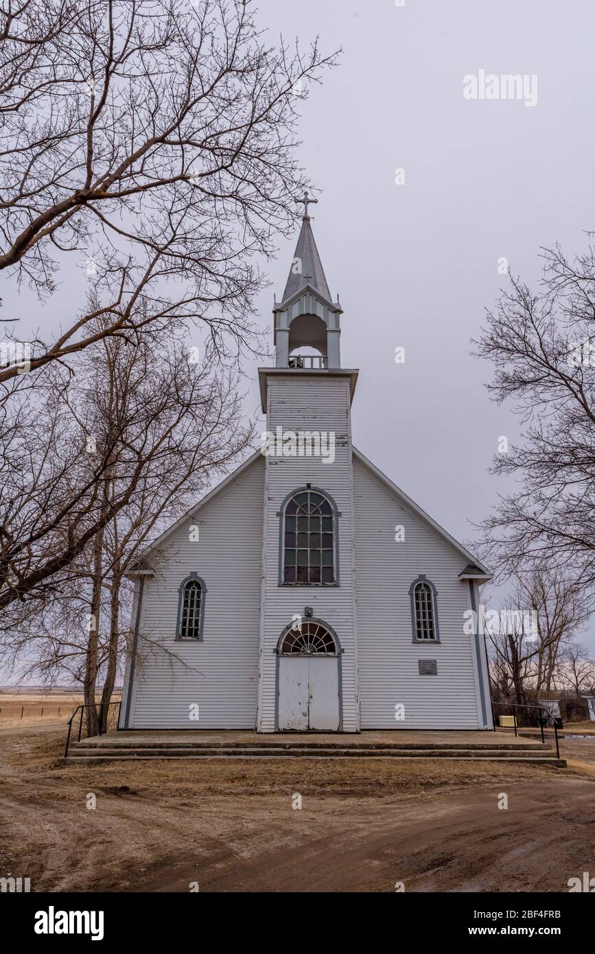 The vintage St. Charles Roman Catholic Church surrounded by trees in Coderre, Saskatchewan The vintage St. Charles Roman Catholic Church surrounded by trees in Coderre, Saskatchewan