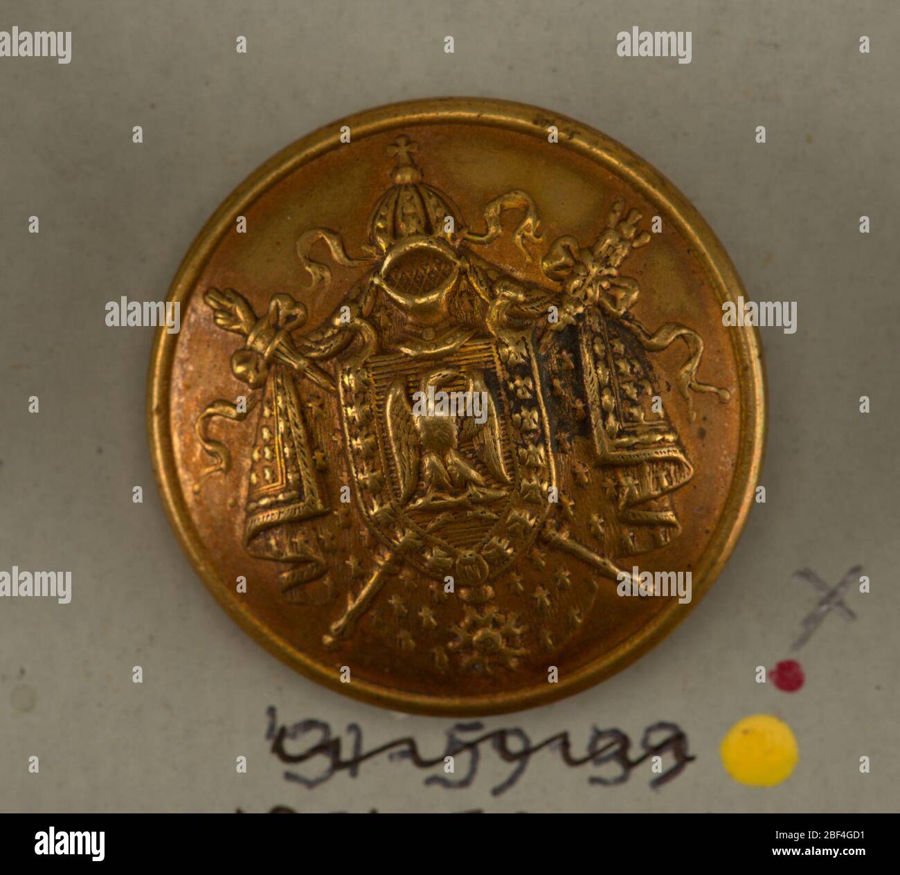 Button. Convex button showing small sheild with eagle on mantling of ermine  cloak and crossed swords; chain with pendant around shield; helmet at  top.On card 45 Stock Photo - Alamy