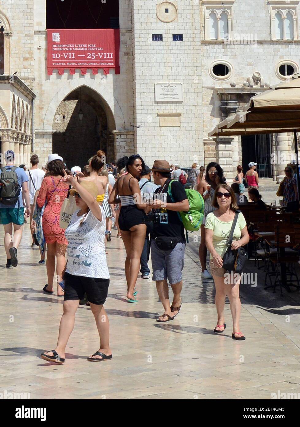 Man & woman exchanging words in Dubrovnik's old town. Stock Photo