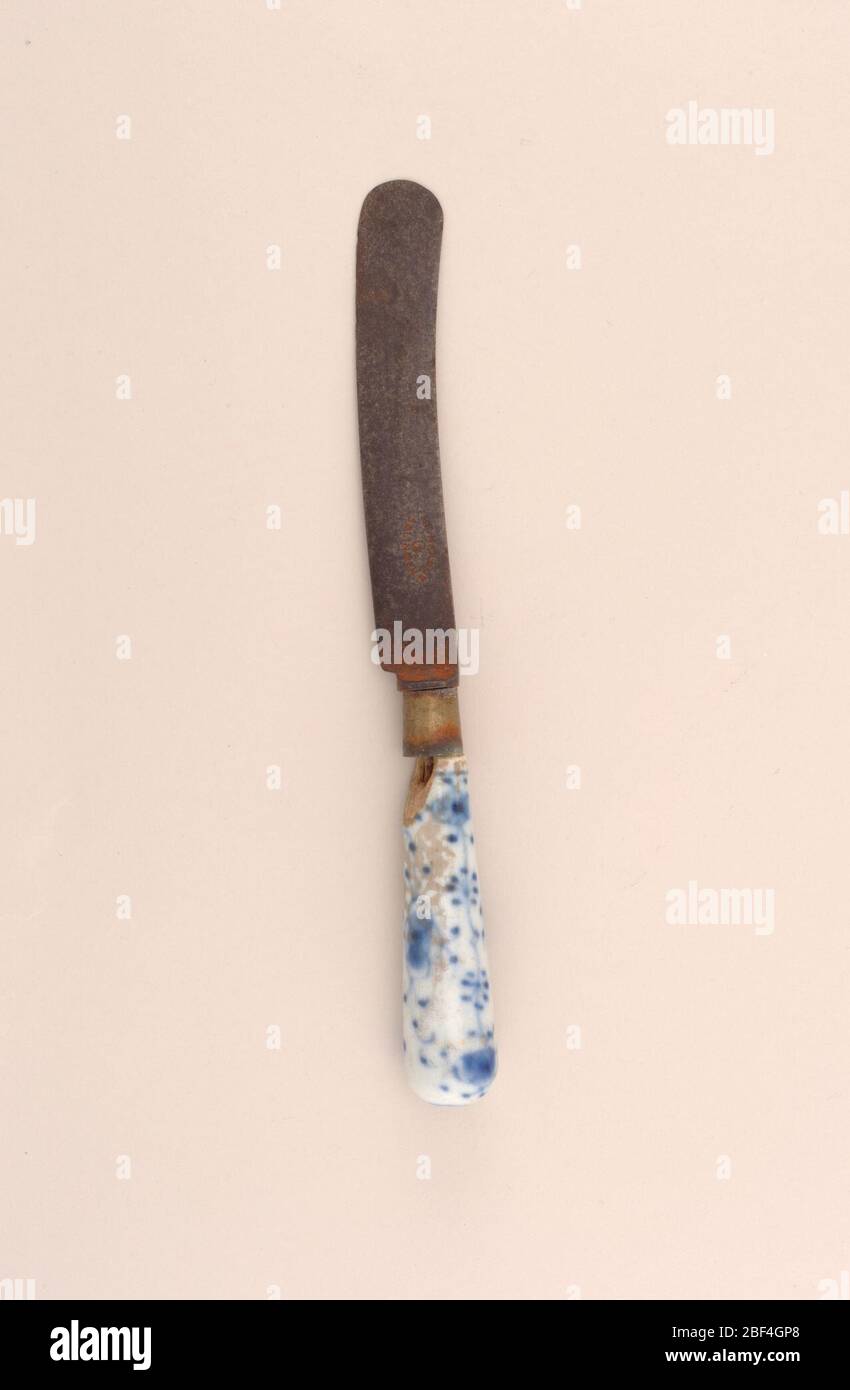 Fork and Knife with Porcelain Handles. knife (a): Slightly curving blade, tapering tubular blue and white porcelain handle decorated with stylized blue flowers and sprigs on a white ground.fork (b): Three tine steel fork, tapering tubular porcelain handle painted with stylized blue flowers and spri Stock Photo
