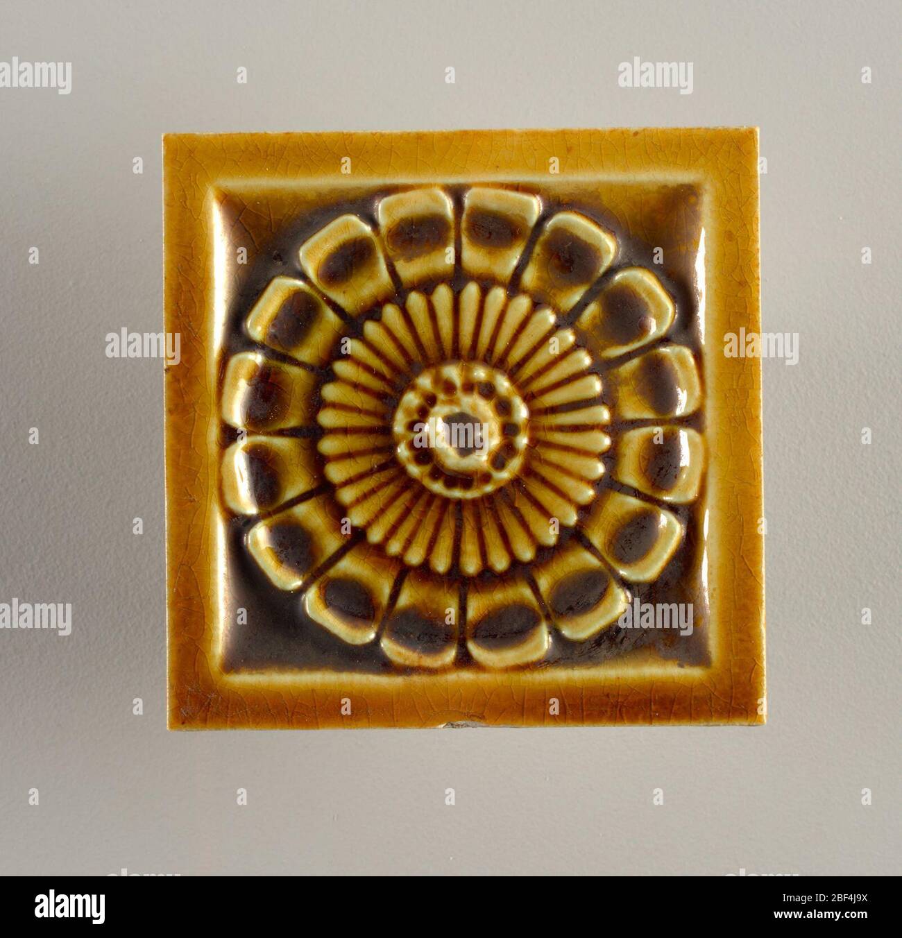 Tile. Square, molded tile of white clay, reverse is embossed with an inscription framed in three concentric circles: J. & J.G. Stock Photo