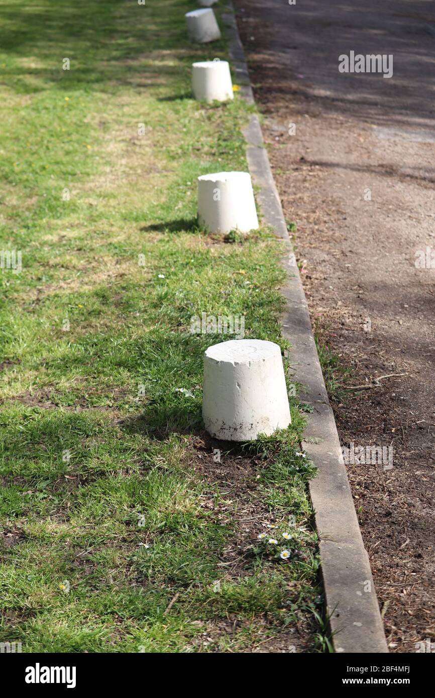 Kerbside bollards to stop parking on grass verge Stock Photo