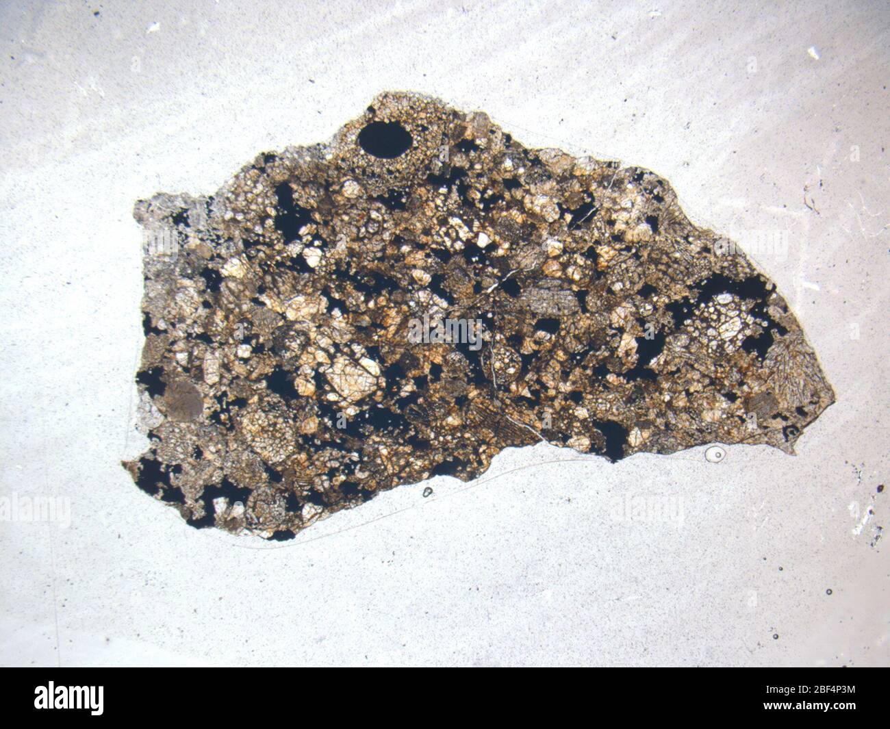 Micrograph of ALHA77191,12 meteorite under plane-polarized light at 1.25x magnification. Stock Photo