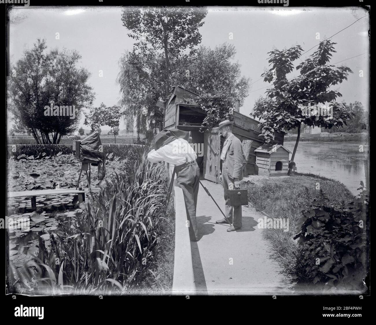United States Fish Commission Hatchery Ponds. Two unidentified men with photographic equipment by the U.S. Fish Commission fish hatchery ponds for the production of carp, golden ide, and tench, located near the grounds of the Washington Monument.Smithsonian Institution Archives, Acc. 11-006, Box 014, Image No. Stock Photo