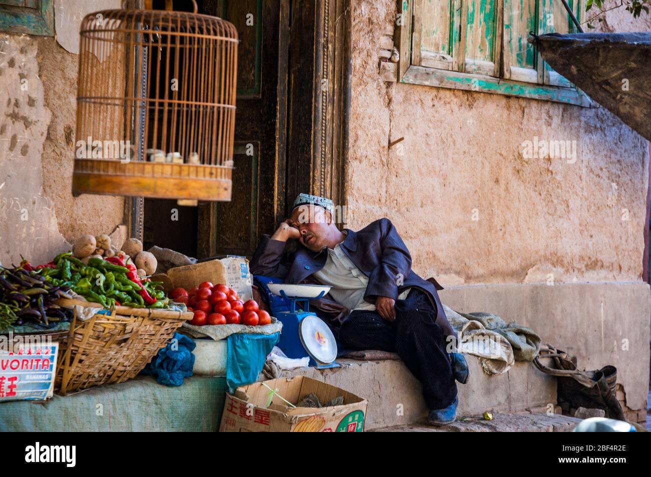 A Uighur Vegetable Seller Asleep On The Job Old Town Kashgar 