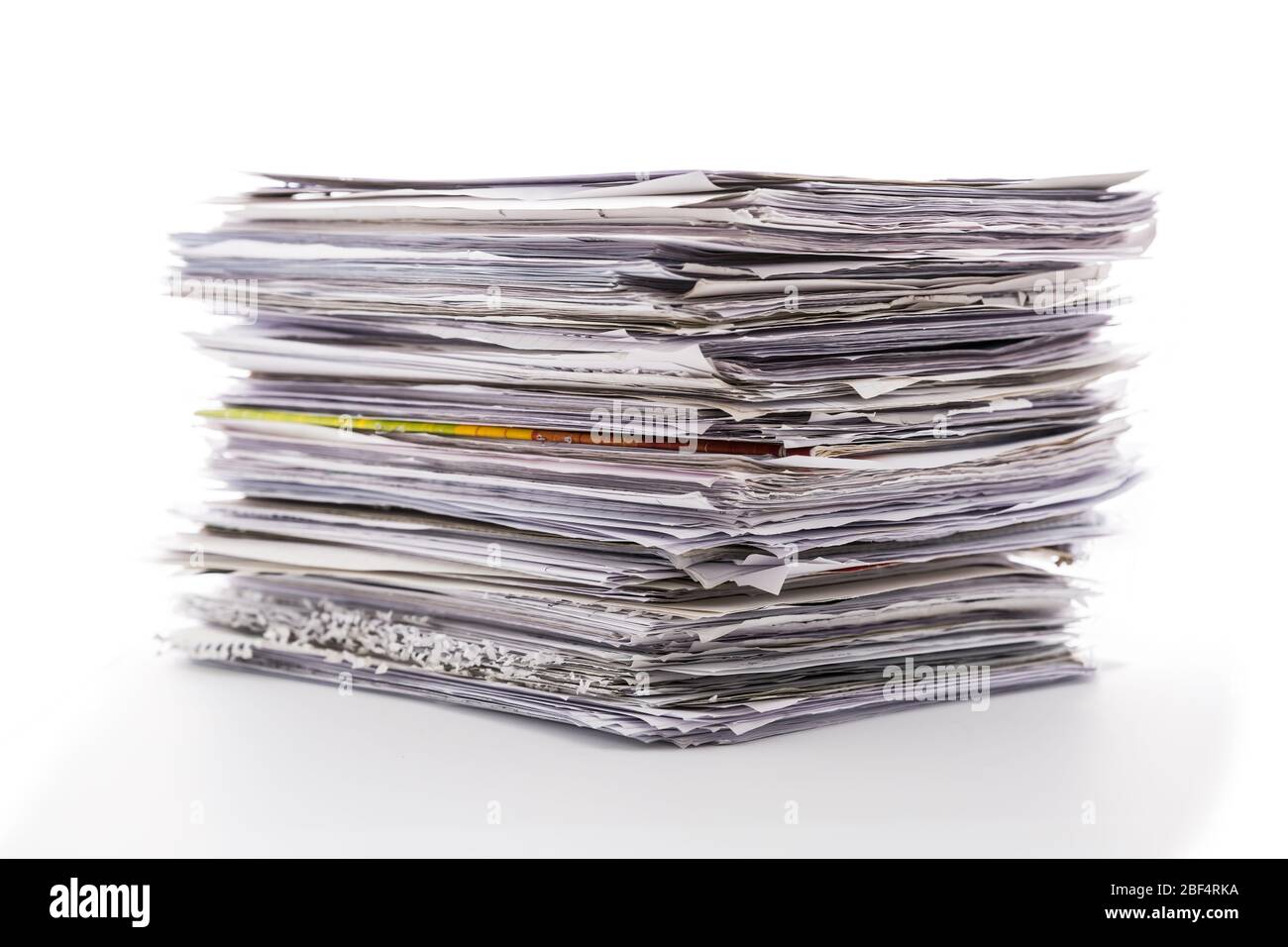 Large pile of waste paper isolated on white. Ready for recycling Stock Photo