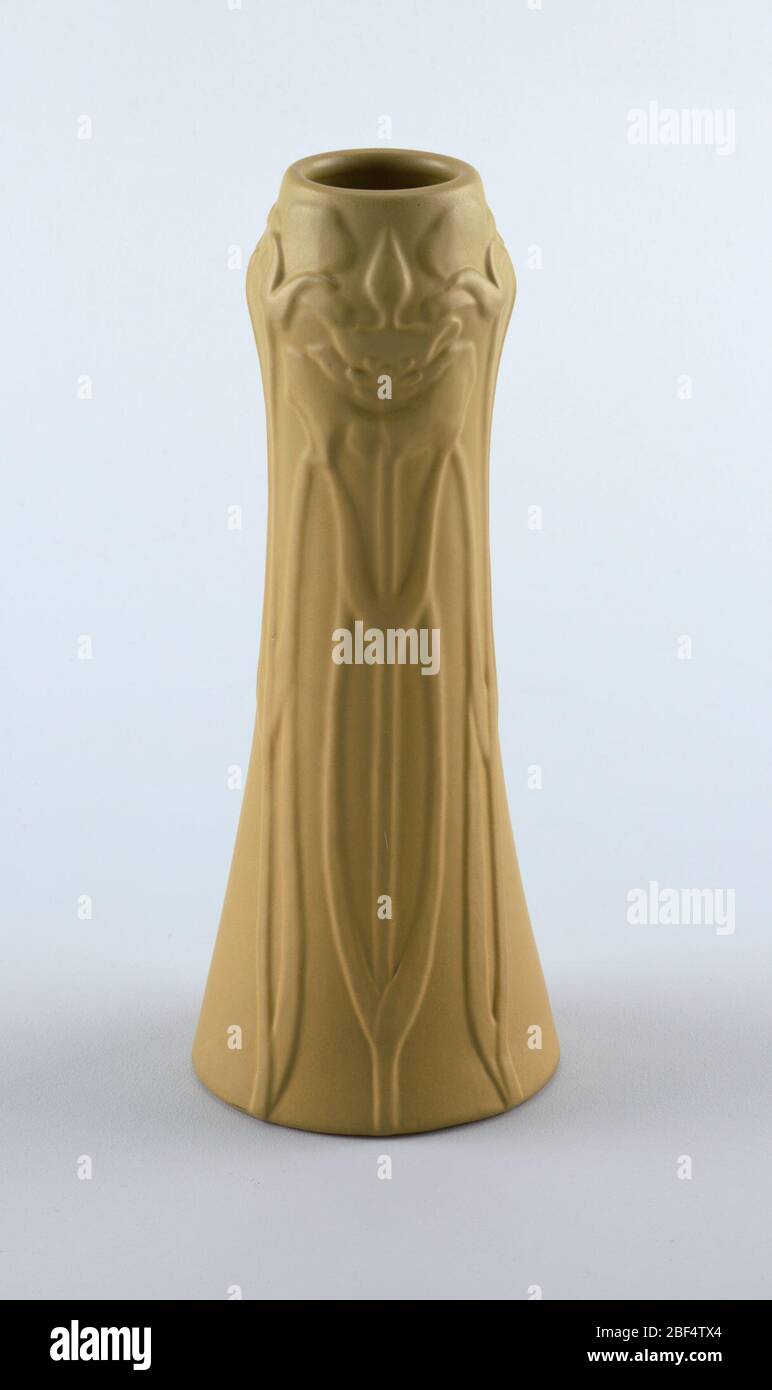 Vase Ochre Colored Clay Body Cast Tall Tapering Cylindrical Body With Slightly Bulbous Shoulder Rises To Rim No Foot Modeled In Low Relief Around Body With Three Groups Of Lily Triads With The Vase Ochre Colored Clay Body Cast Tall Tapering Cylindrical Body With Slightly Bulbous Shoulder Rises To Rim No Foot Modeled In Low Relief Around Body With Three Groups Of Lily Triads With The