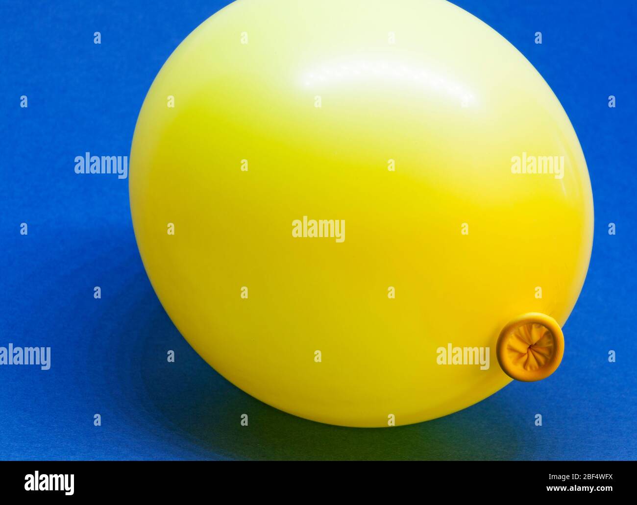 a yellow balloon on blue background Stock Photo