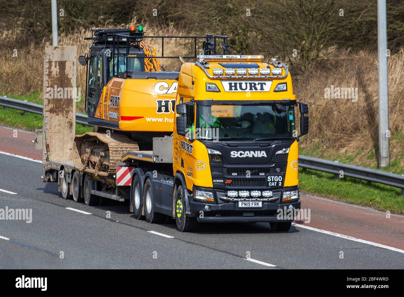 Hurt Plant Hire Ltd Haulage delivery trucks, lorry, transportation, truck, cargo carrier, Scania R500 XT vehicle, European commercial transport, industry, M6 at Manchester, UK Stock Photo