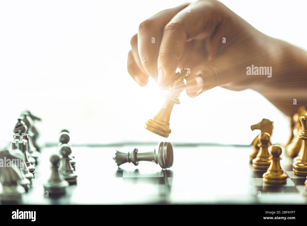 Closeup hand playing chess boardgame checkmate for win business concept. Stock Photo