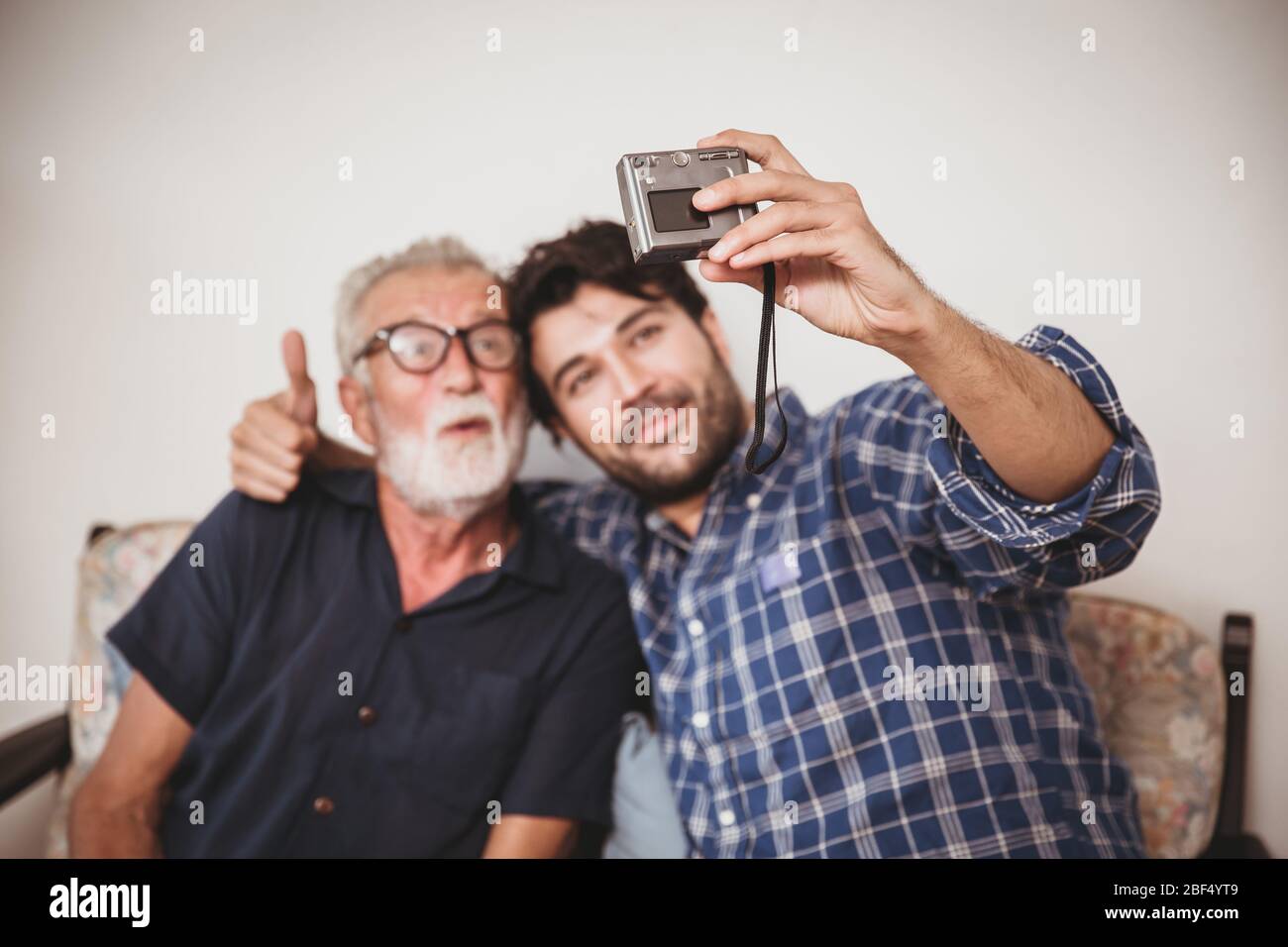 Happy elder, Son take a photo selfie with his uncle happy family with