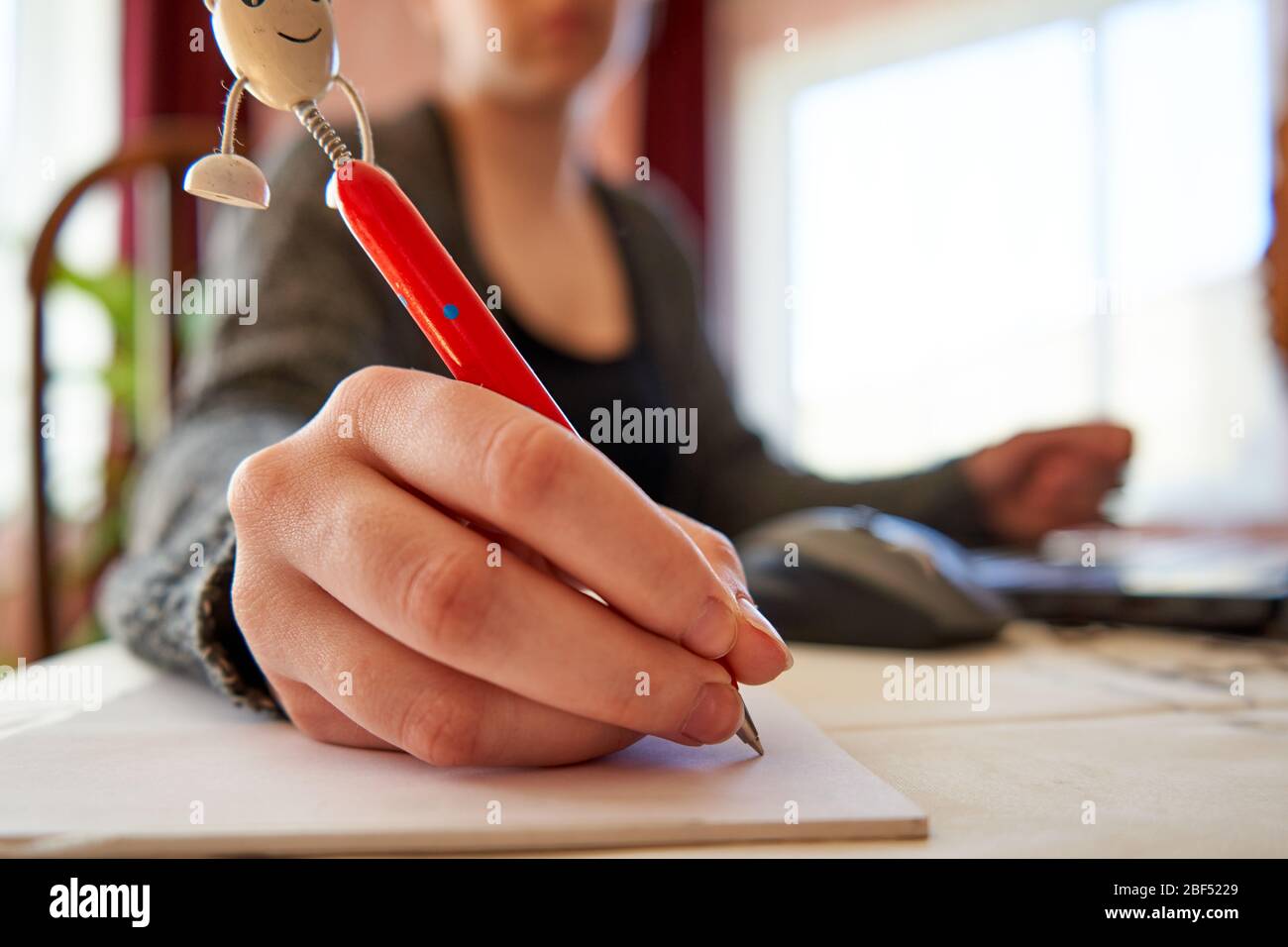 Woman writing text on paper. Home office. Working from home. Stock Photo
