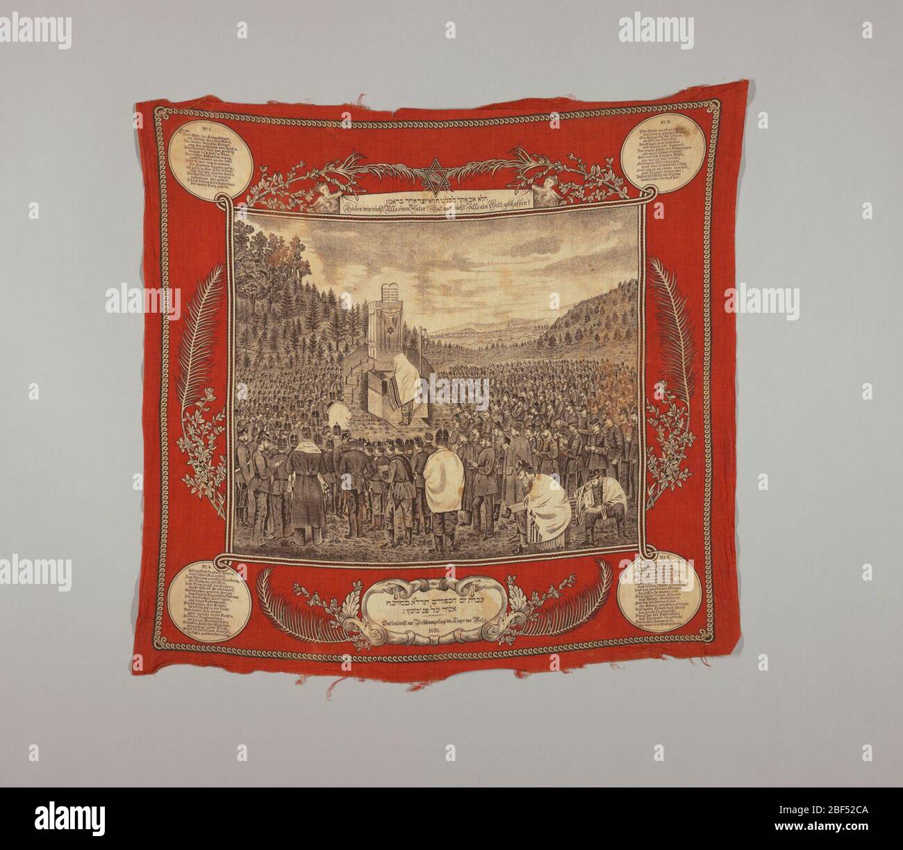 Commemorative scarf. Scarf with central picture of a Jewish Kol Nidre ceremony on a corner of a battlefield. Individual regiments can be identified by numbers on the epaulettes. Text in Hebrew and German. Stock Photo