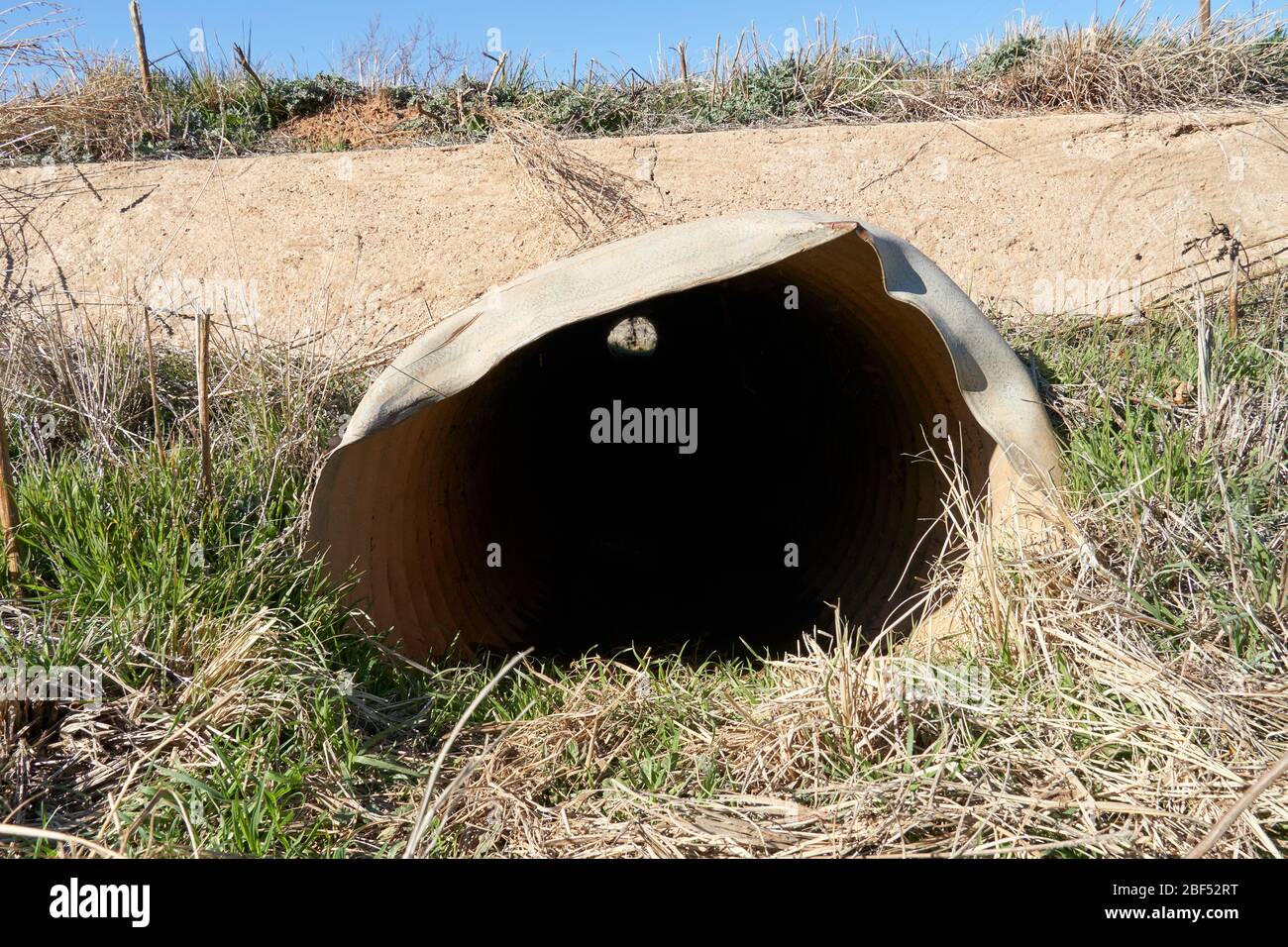 End view of Small culvert under a farm to market road in Texas Stock Photo