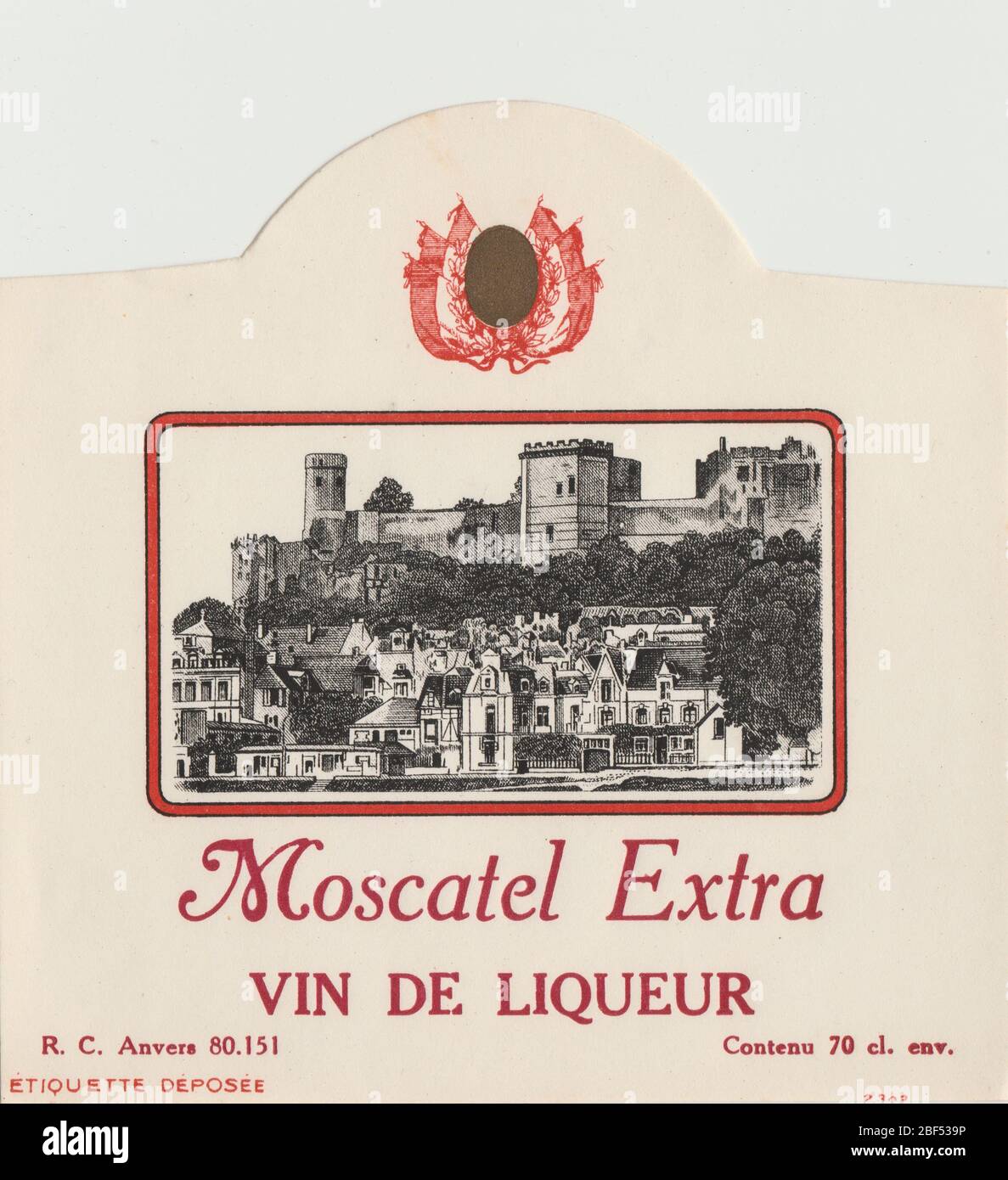 Unused and rare vintage label from a Moscatel wine, vin de liqueur. Label is decorated with a French village and a castle on a hill. Stock Photo