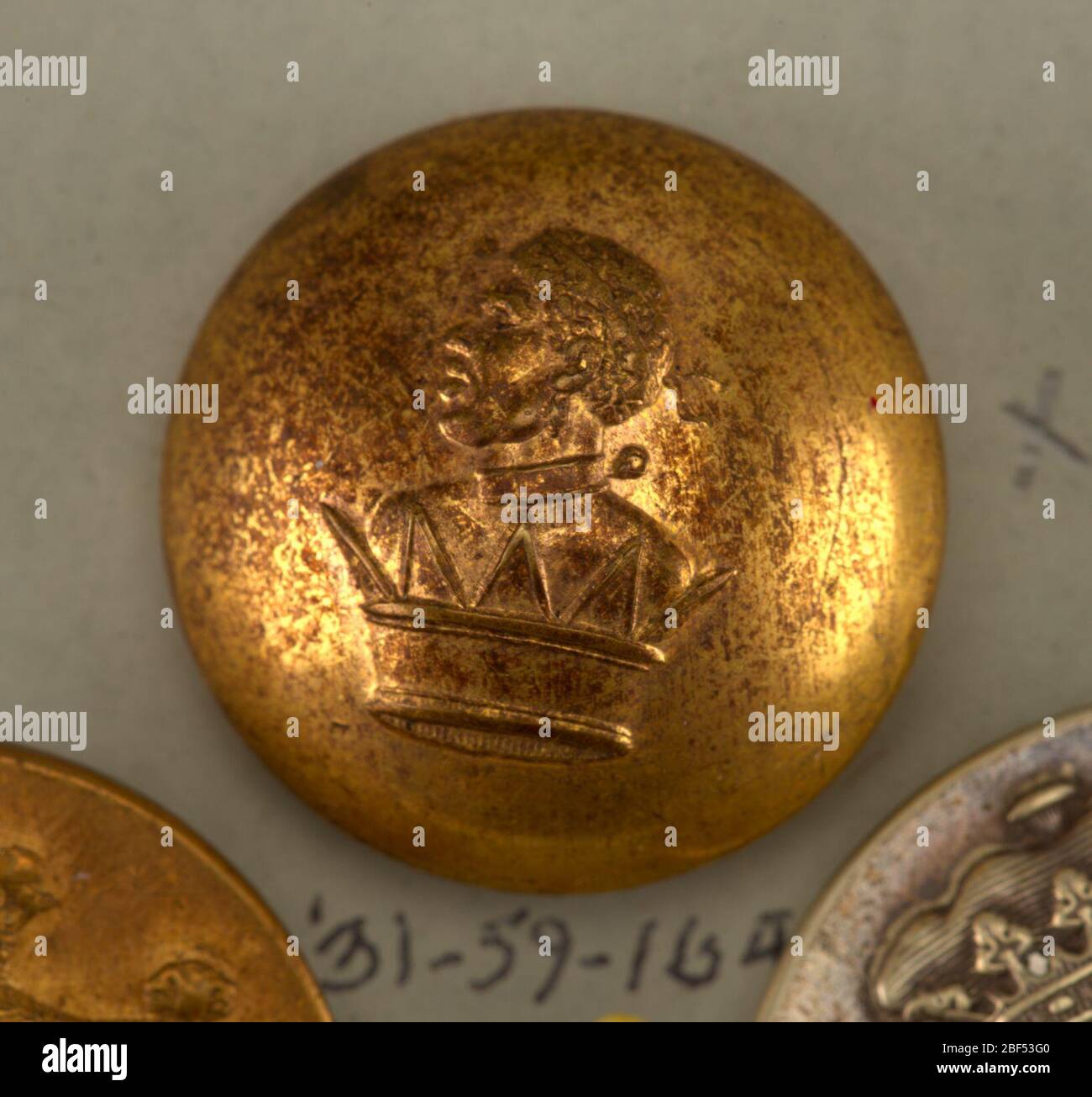 Button. Convex button ornamented in design showing a crown out of which ...