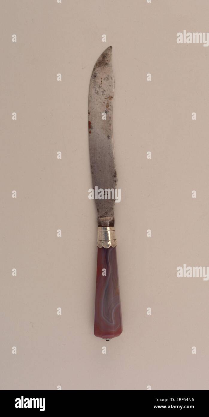 Knife. Sabre-shaped blade with curved upper edge. Plain bolster, silver engraved ferrule with scalloped border. Flaring, faceted agate handle, silver conical mount on top. Stock Photo