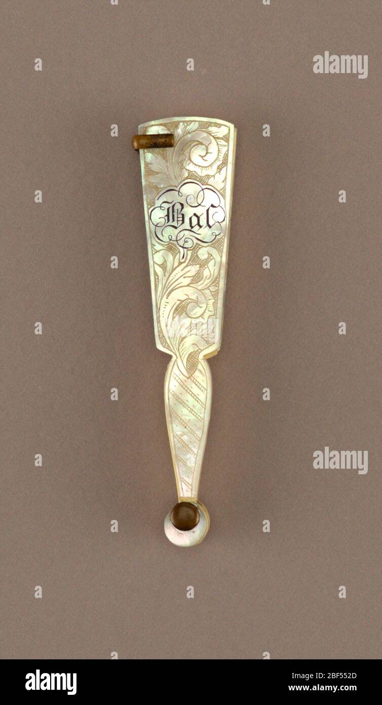 Bris Carnet de Bal. Brisé Carnet de Bal (dance card) fan. Ivory and carved mother-of-pearl sticks and guards with floral motif. Metal pencil holder. Stock Photo