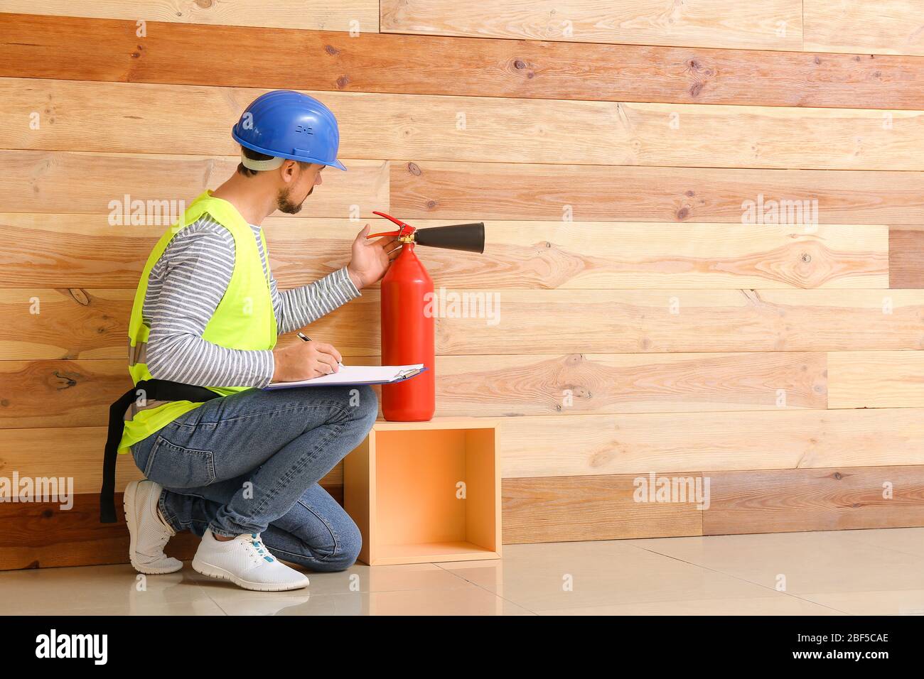 Fire safety specialist inspecting extinguisher Stock Photo Alamy