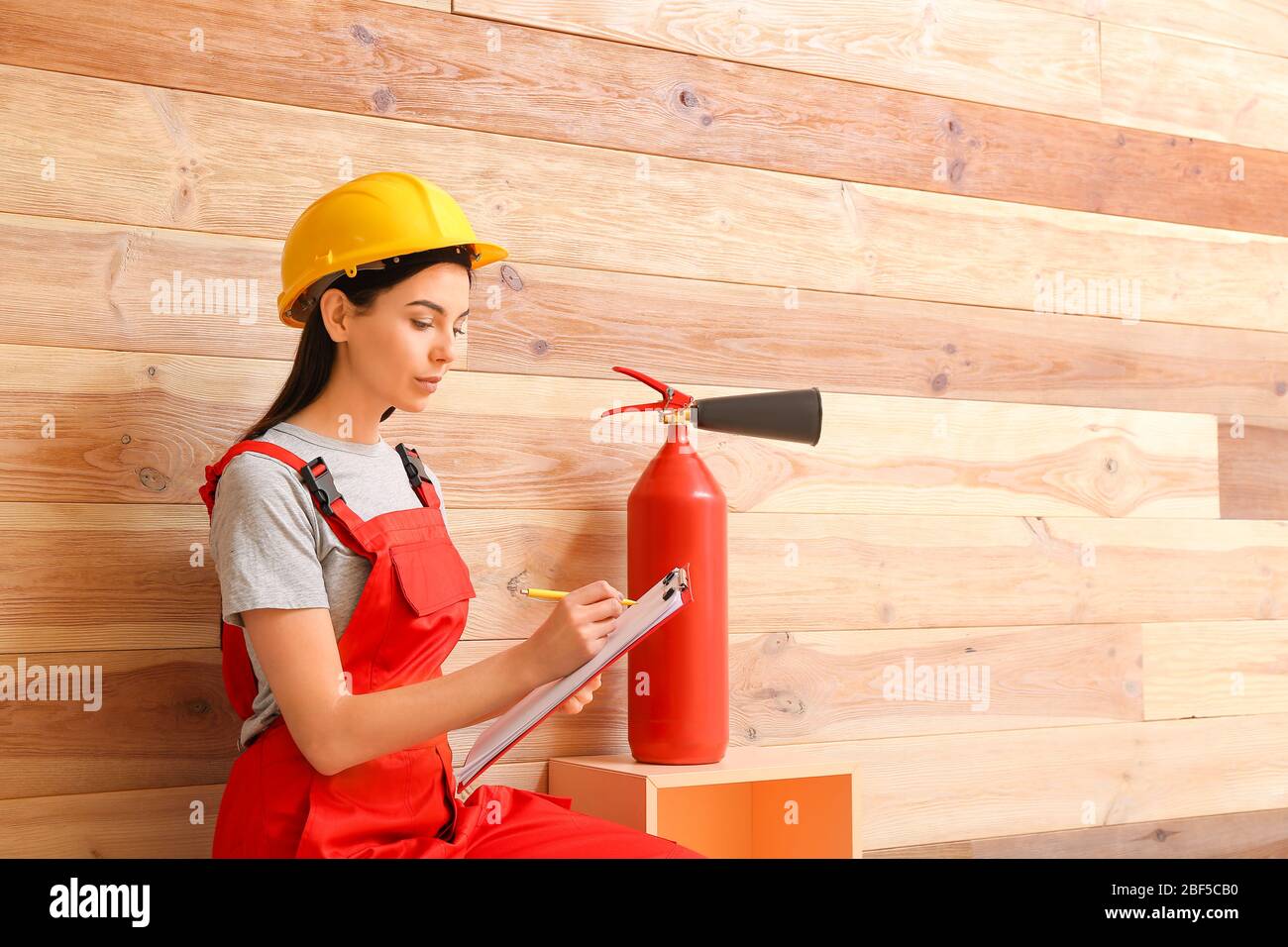 Fire safety specialist inspecting extinguisher Stock Photo Alamy