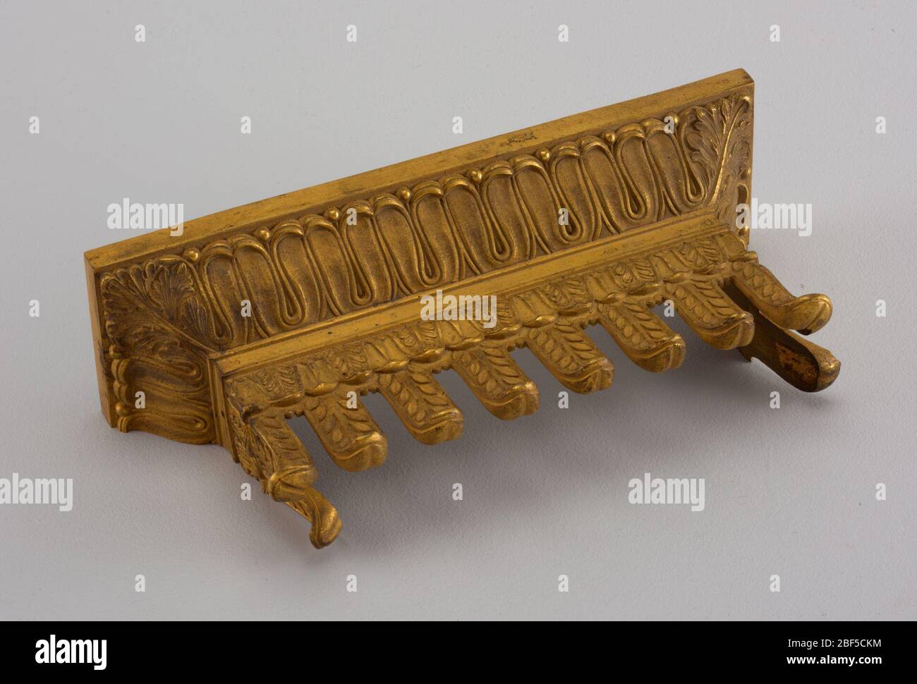Mount. Architectural or funiture cornice with lapped tongue decoration of acanthus corners over frieze of pendant tongues over cut-out with laurel decoration Stock Photo