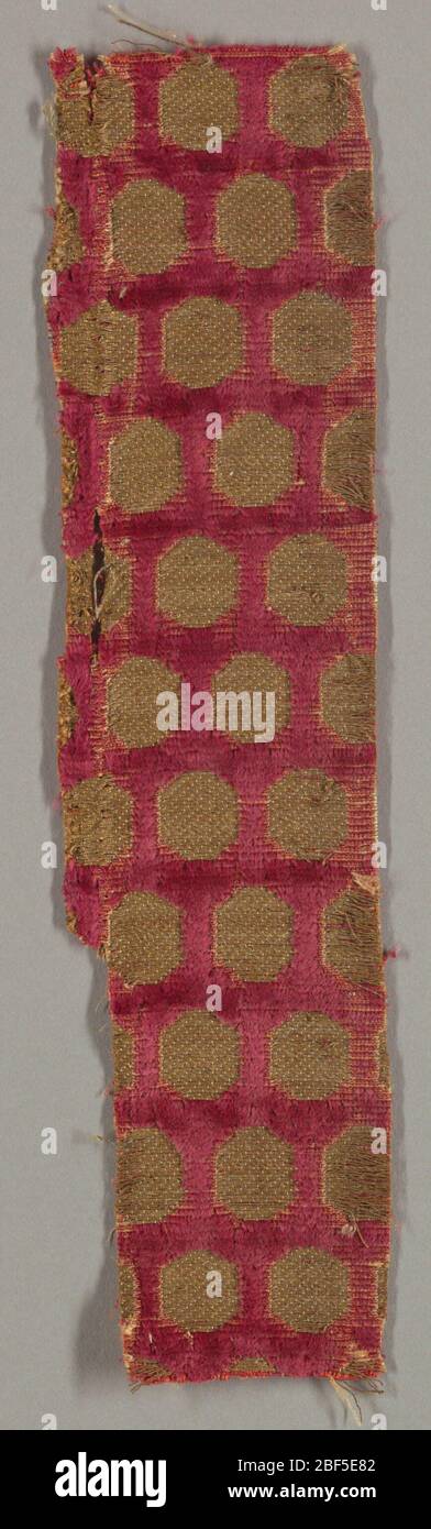 Fragment. Deep red velvet with offset rows of gold metallic thread ...