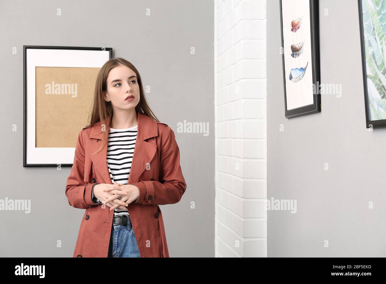 Young woman at exhibition in modern art gallery Stock Photo - Alamy