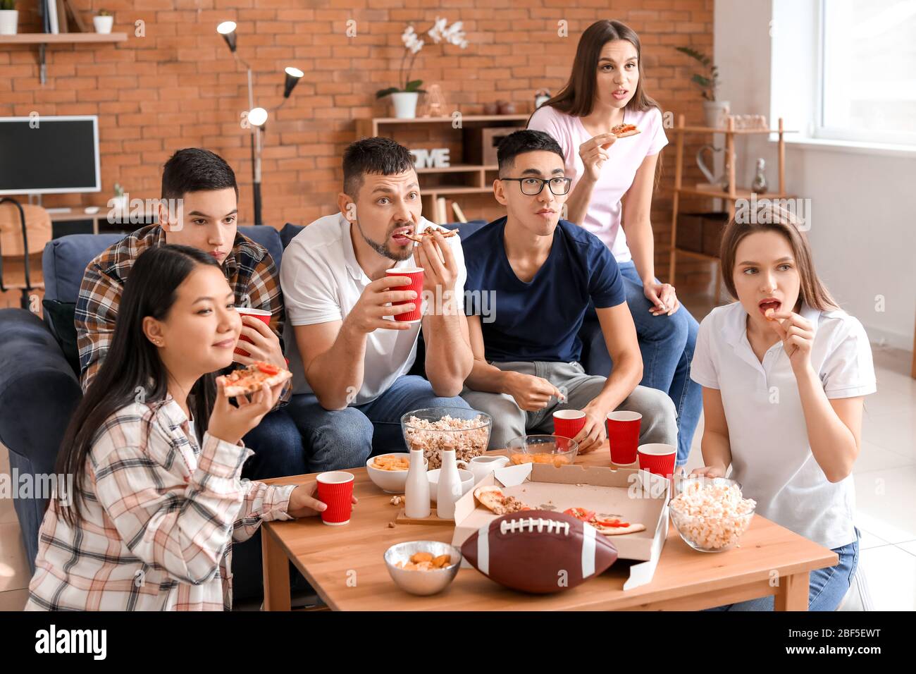 Group of fans watching rugby on TV Stock Photo Alamy