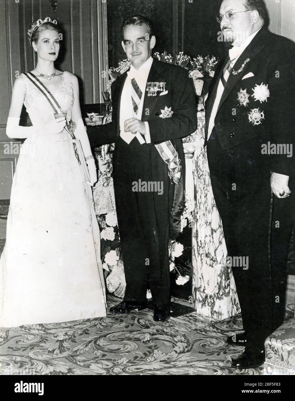 GRACE KELLY (1929-1982) American film actress as Princess Grace of Monaco with Husband Prince Ranier and King Farouk of Egypt at right in 1956 Stock Photo