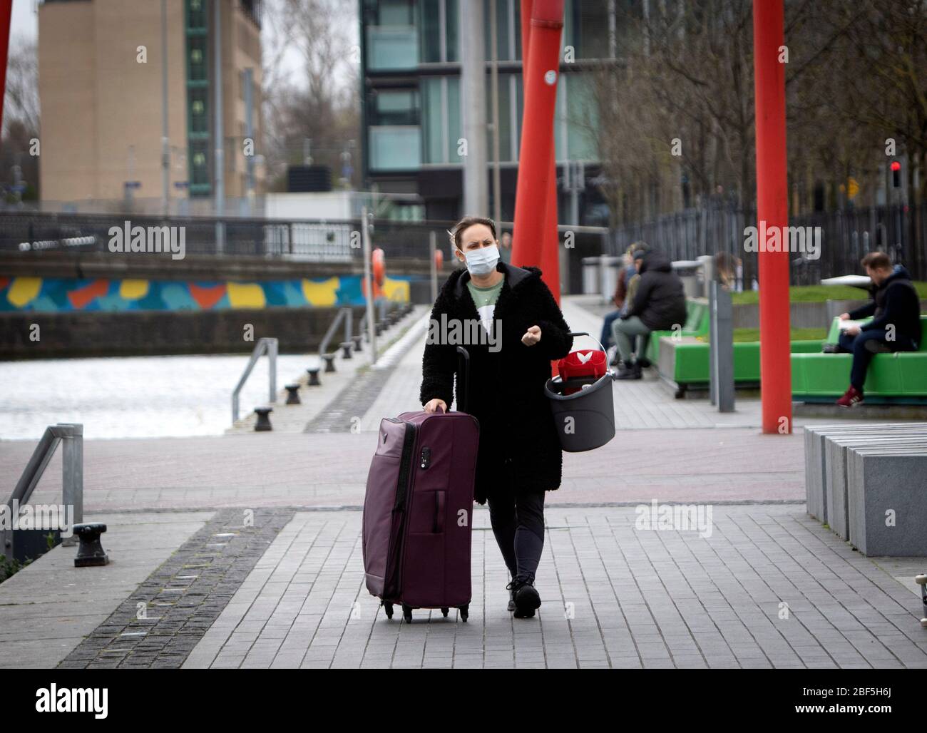 Dublin, Ireland - April 6, 2020: a woman wearing a face mask at Grand Canal Dock during Covid-19 lockdown restrictions in the city. Stock Photo