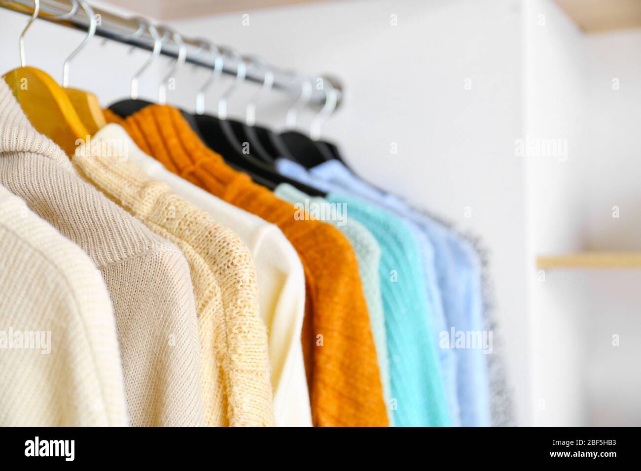 Stylish clothes on hangers in modern store Stock Photo - Alamy