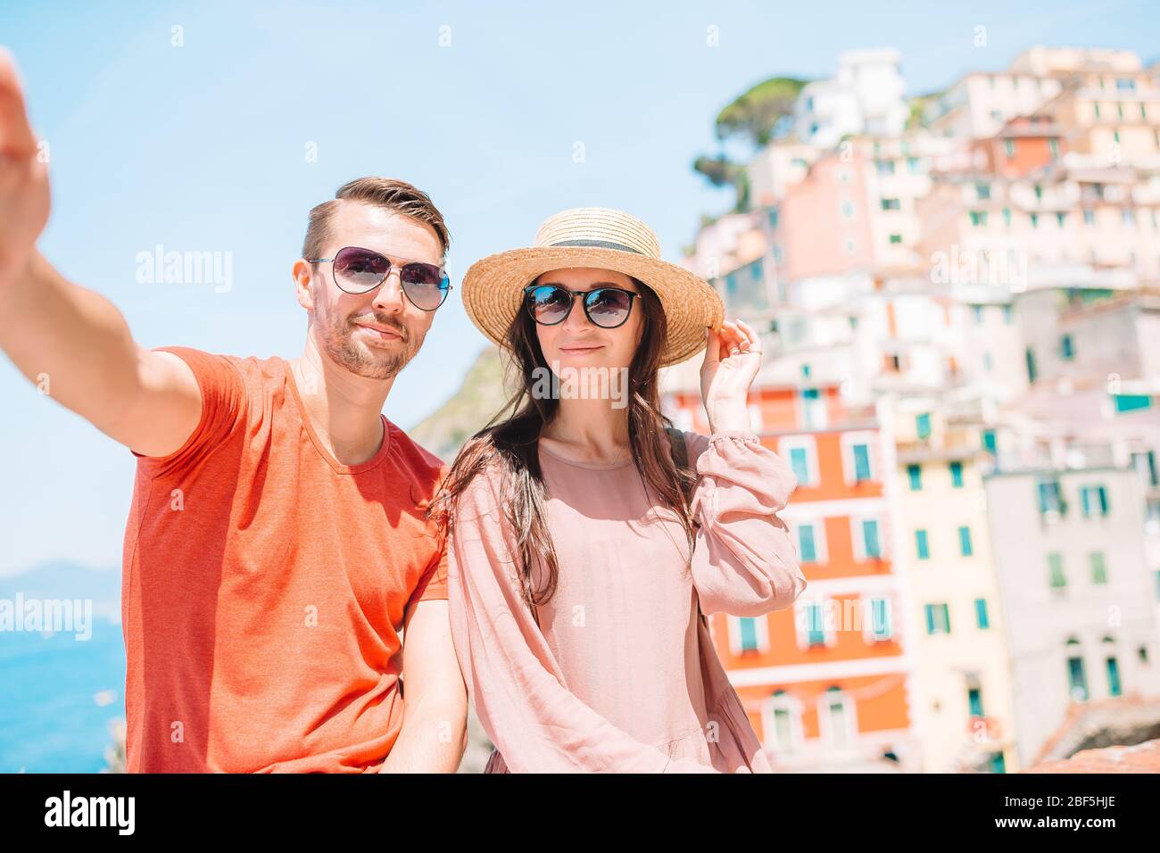 Young tourist couple traveling on european holidays outdoors in italian vacation in Cinque Terre Stock Photo