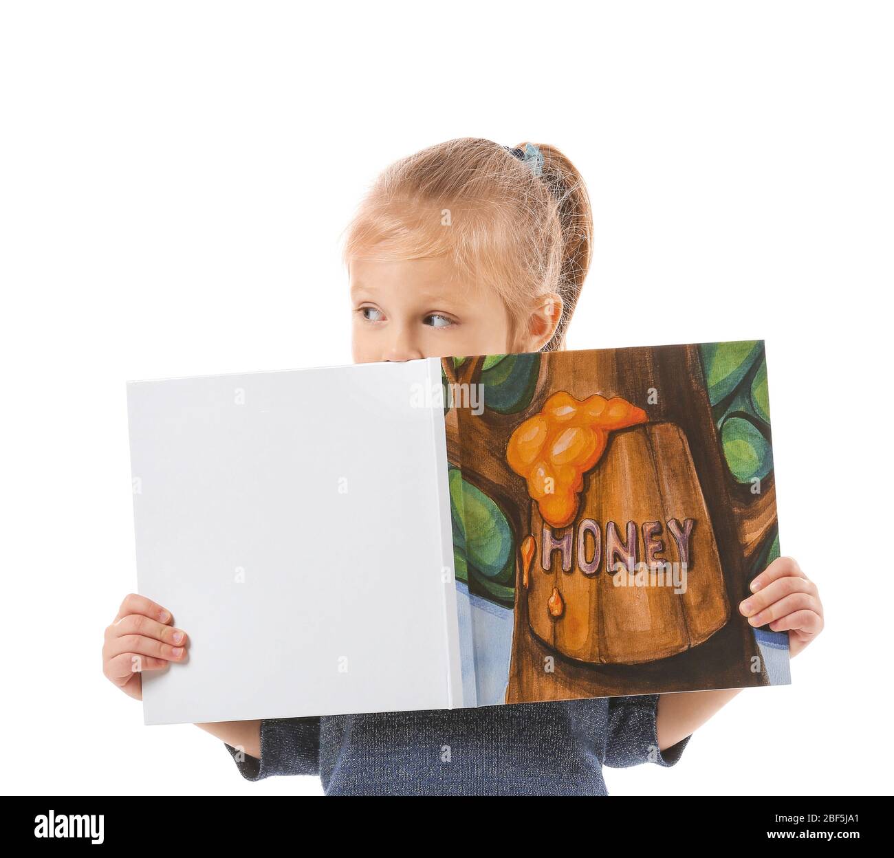 Cute little girl reading book on white background Stock Photo - Alamy