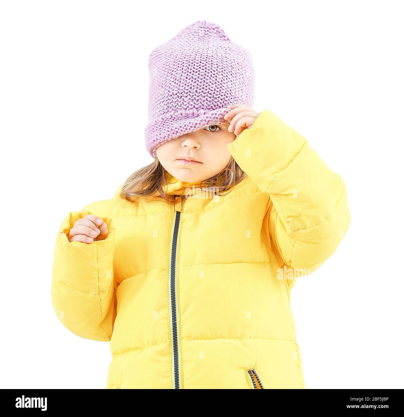 Cute little girl in winter clothes on light background Stock Photo - Alamy
