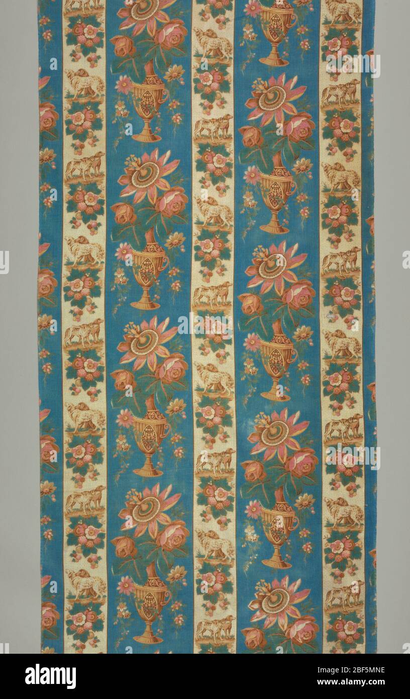 Textile. Part of cover or curtain, of cotton striped in blue and white with printed designs in stripes. In blue, a vase with flowers; in white, groups of dogs alternating with flowers. Trimmed with red and white cotton fringe. Two breadths each 29 inches wide. Stock Photo