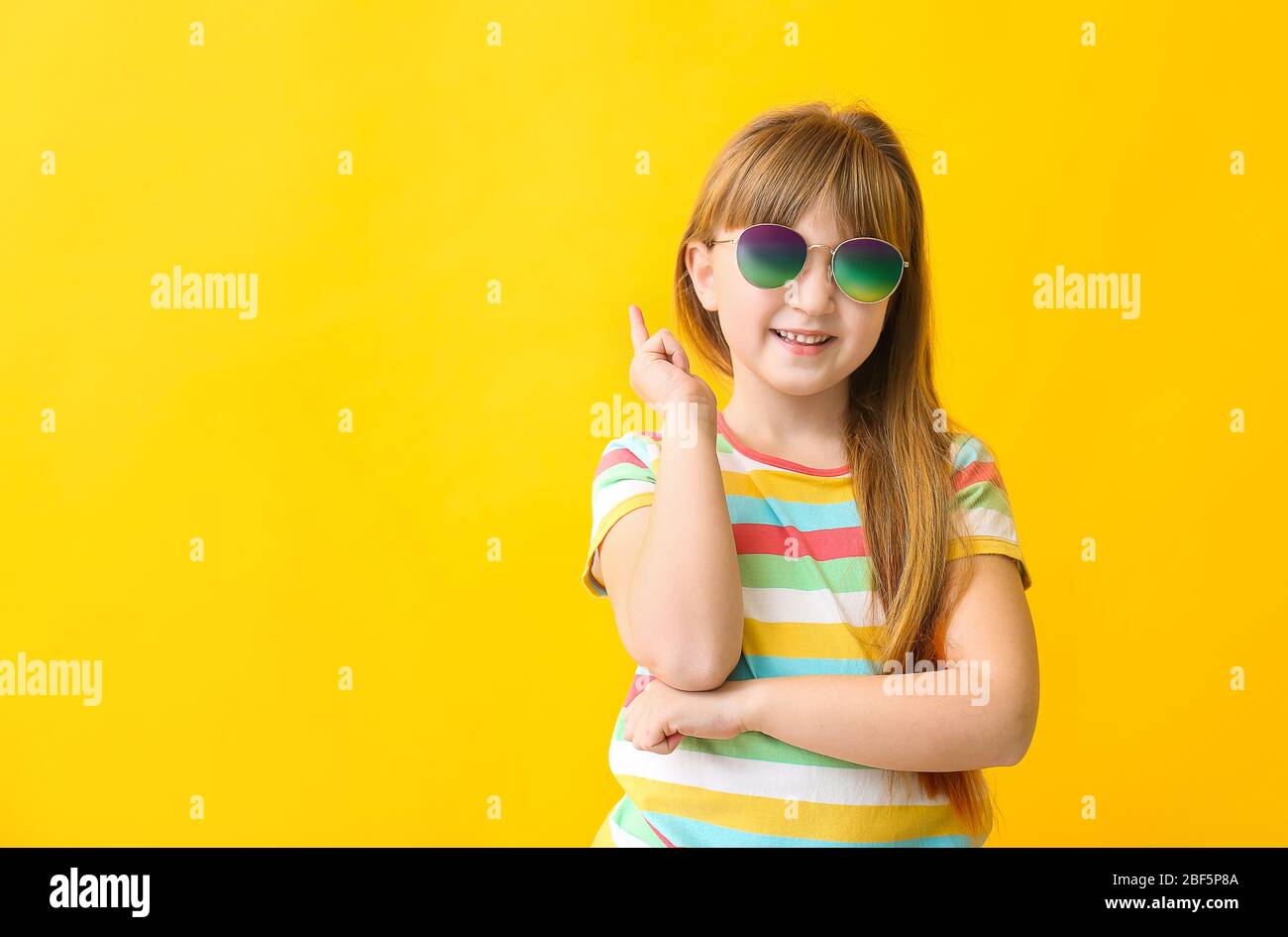 Funny little girl with sunglasses on color background Stock Photo - Alamy