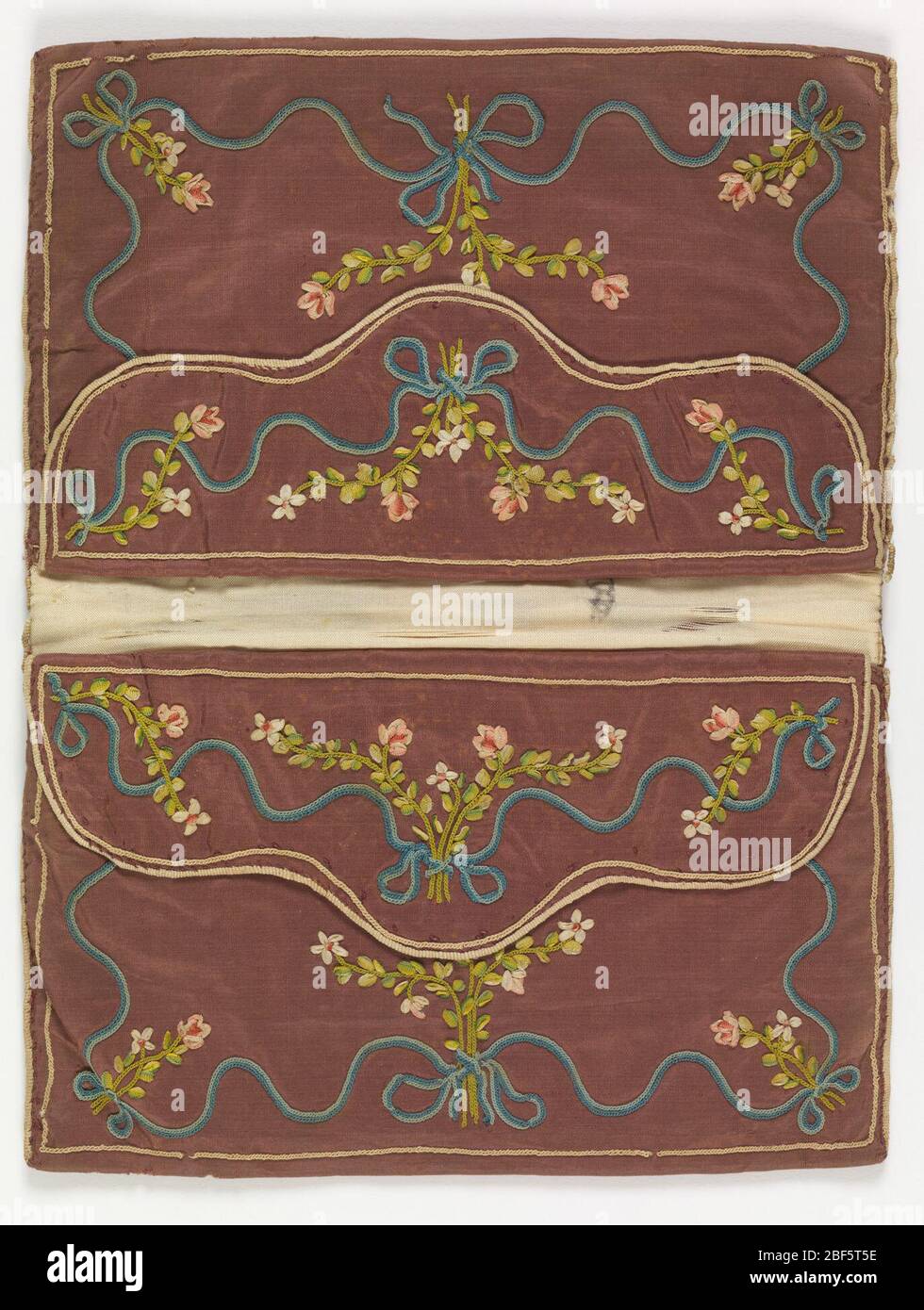 Letter case. Rectangular letter case in purple silk taffeta, now faded, embroidered with ribbons and colored silks. Inside the double envelope are pouches with flaps, all embroidered in similar floral patterns. Lined with white silk taffeta. Stock Photo