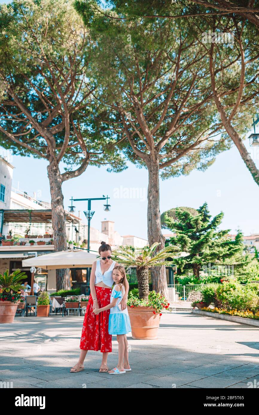 Adorable little girl and young mother in italian old village Stock