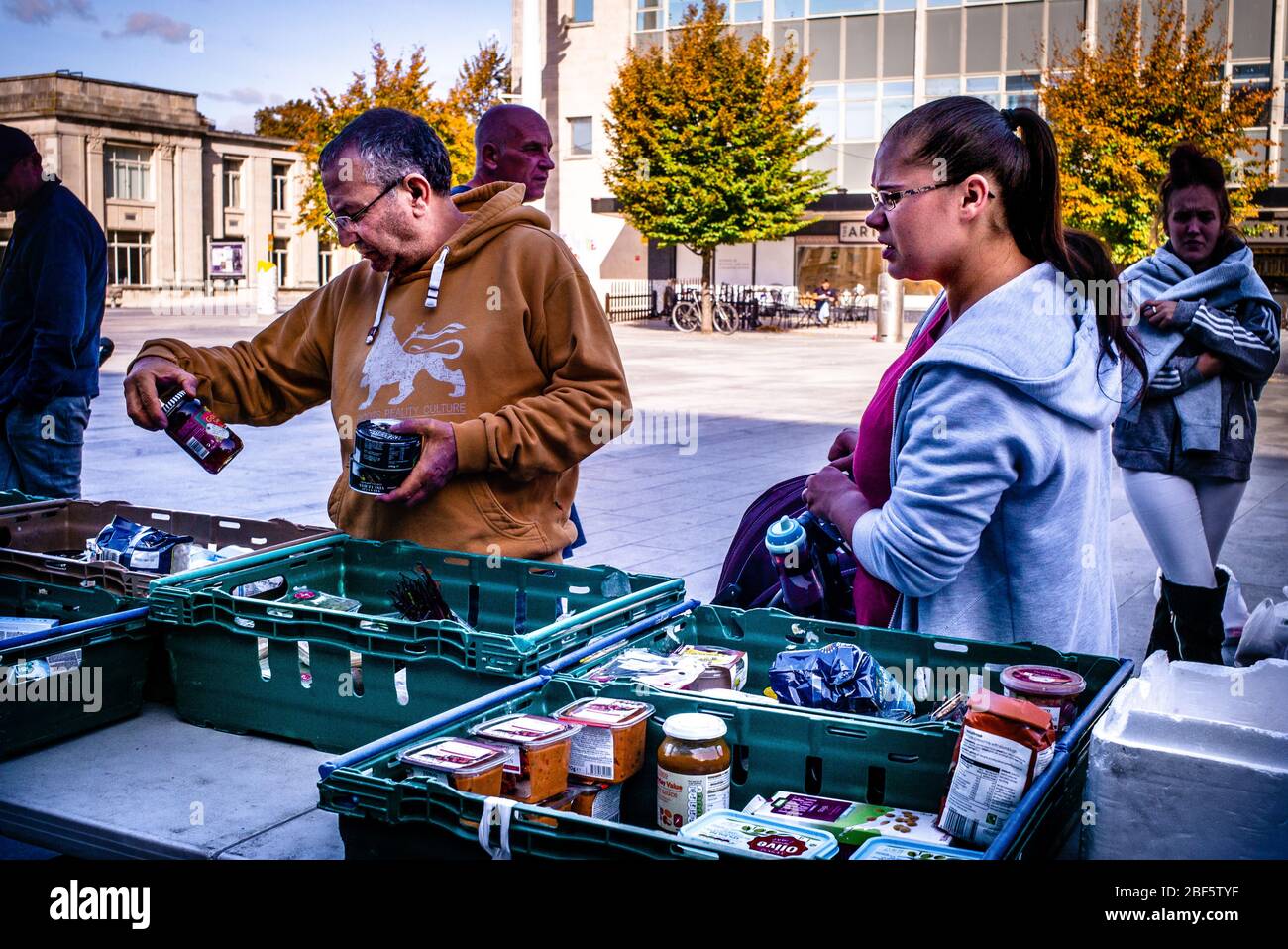 A young mother waits to look at the free food at a food bank organised by a local religious group in the port city of Southampton, England. Stock Photo