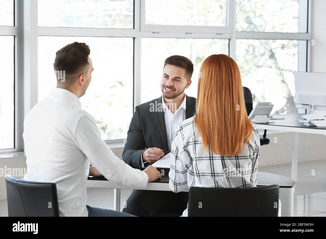 Bank manager working with clients in office Stock Photo - Alamy
