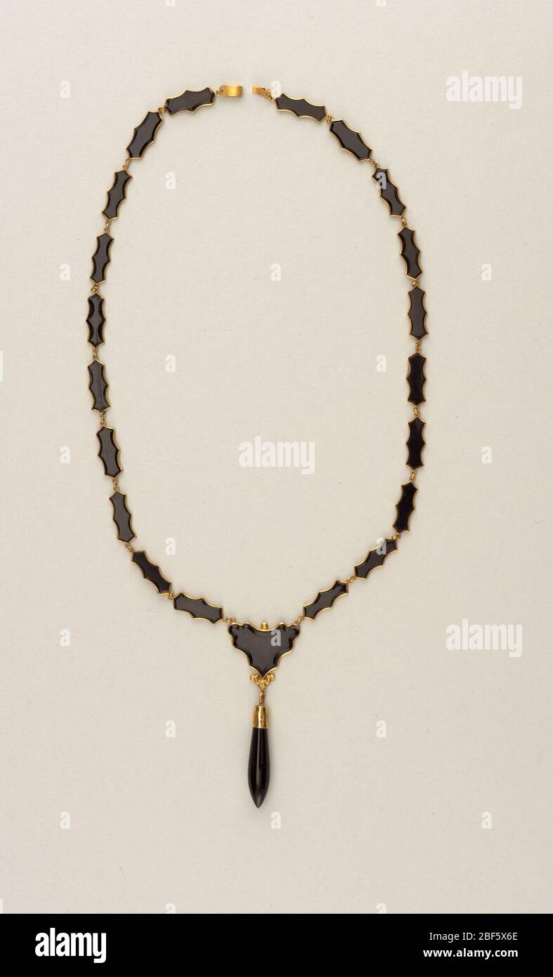 Necklace. Link necklace with clasp: twenty shaped pieces of onyx set in gold and one heart-shaped piece with gold setting and ornament with ring (possibly part of a pendant now missing). One piece of onyx is broken. Stock Photo
