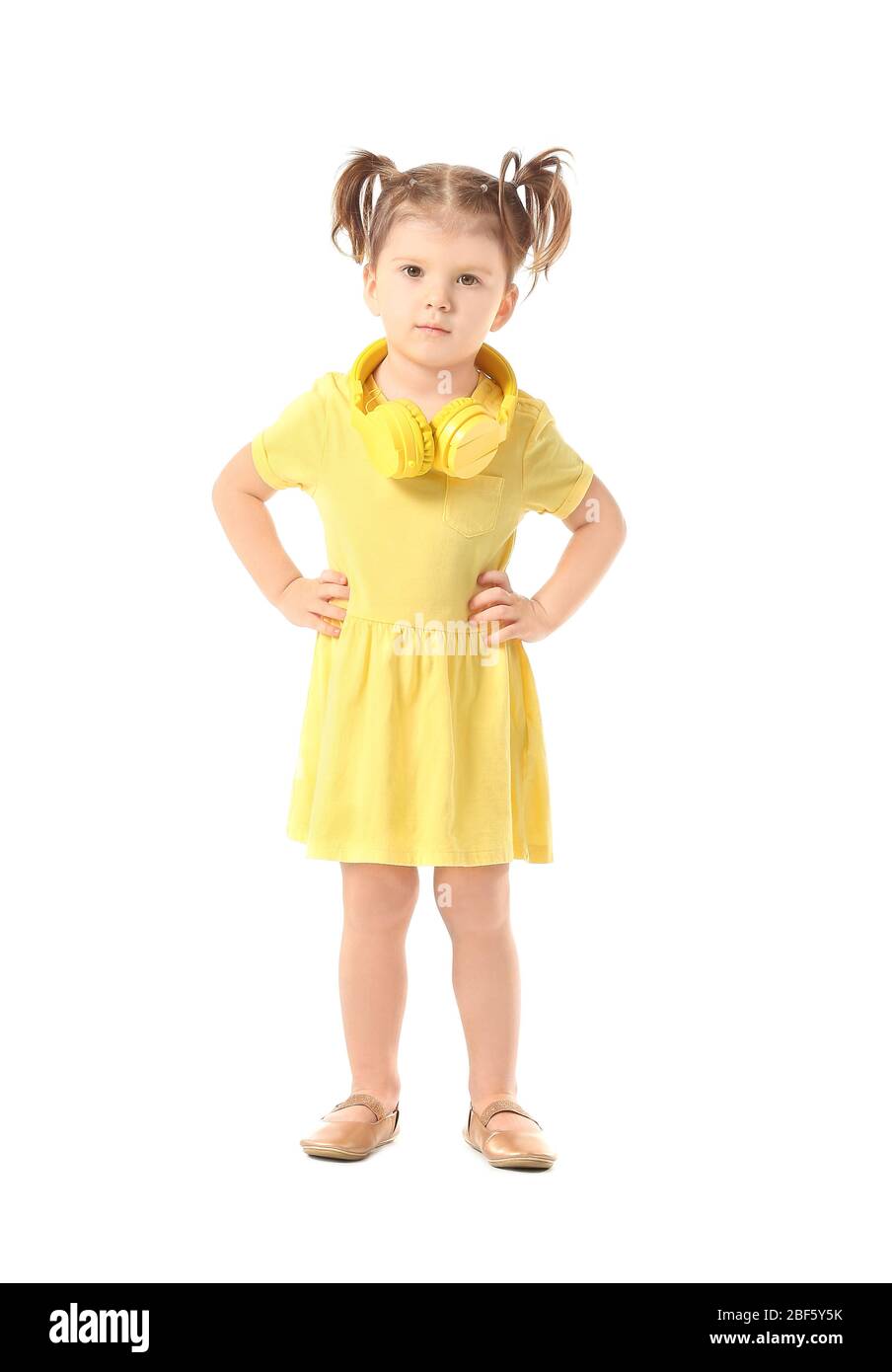 Cute little girl with headphones on white background Stock Photo - Alamy