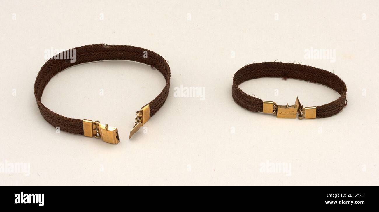 Bracelets. A) Bracelet composed of a flat band of brown hair with gold  clasp marked: "H. L. Thorn".B) Bracelet composed of a flat band of brown  hair with gold clasp marked "E. A.