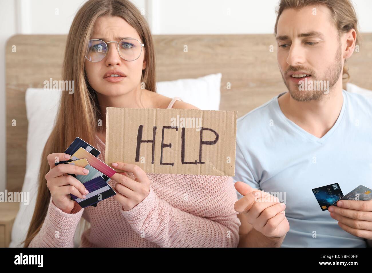 Worried young couple in debt at home Stock Photo