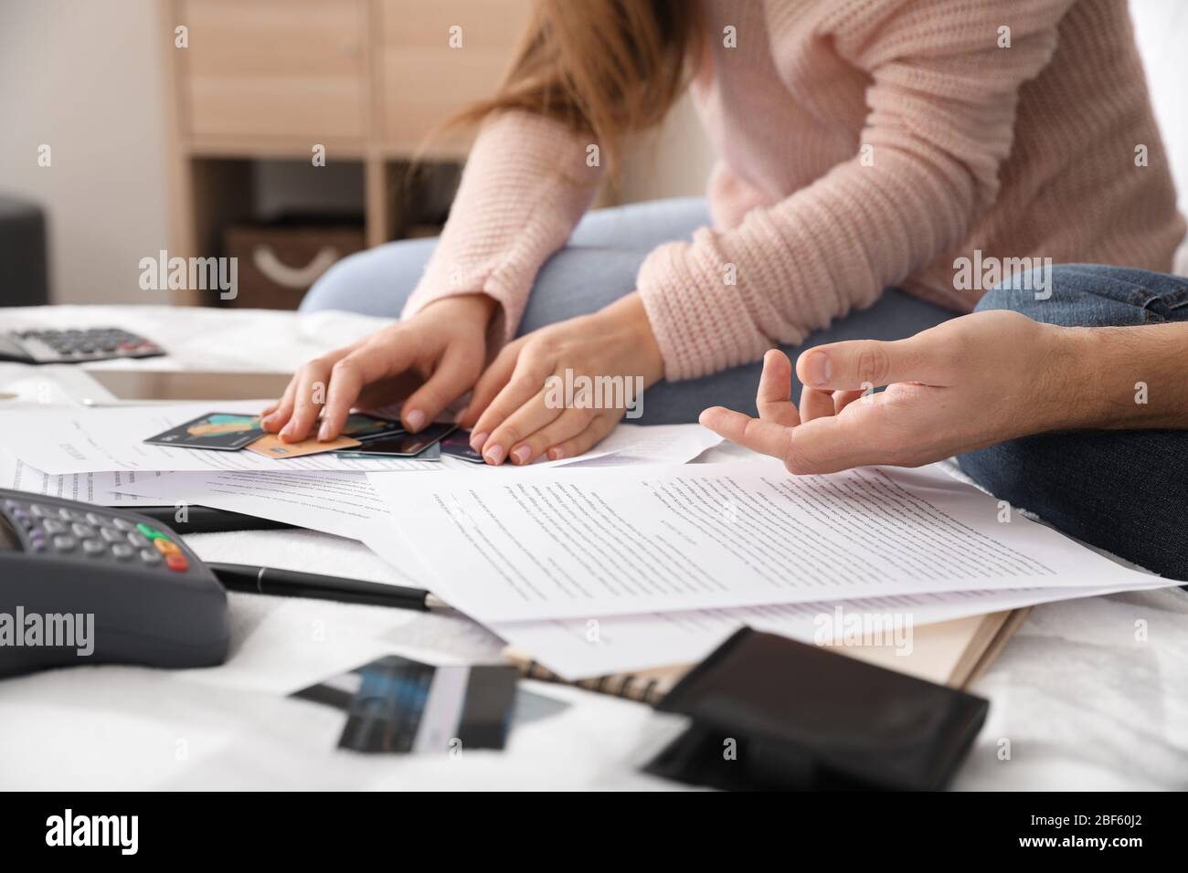 Young couple in debt at home, closeup Stock Photo