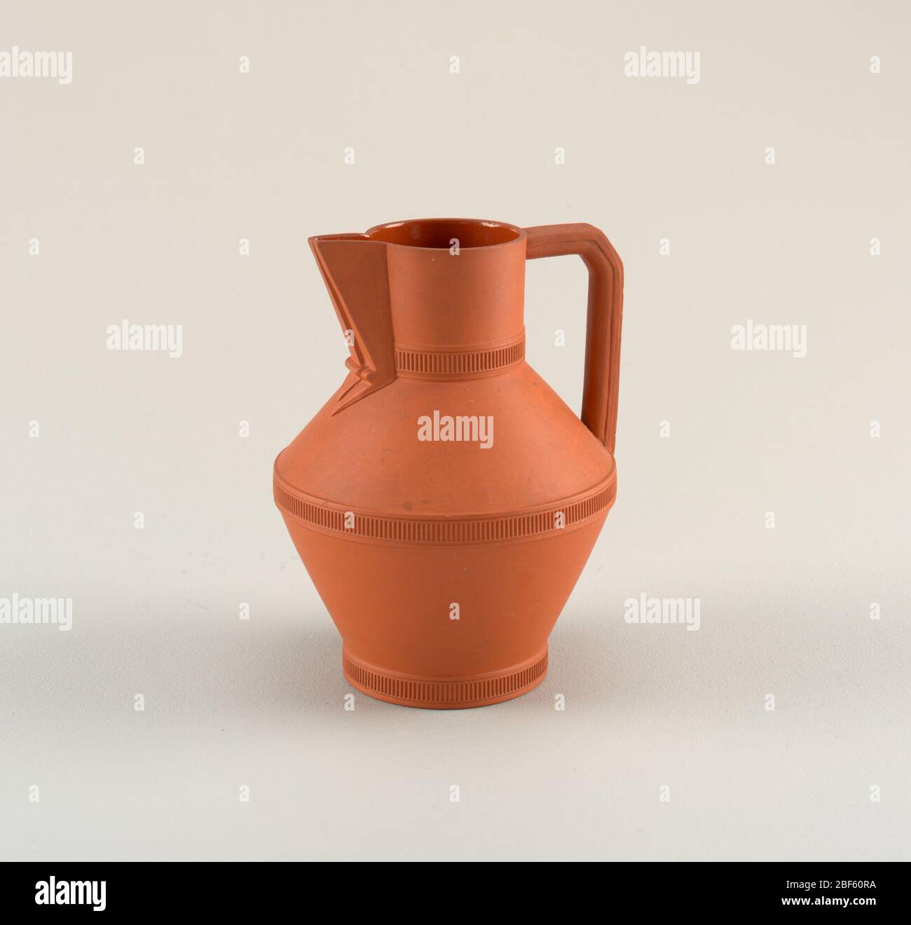 Jug. Angular pitcher form with three horizontal bands at the base ...