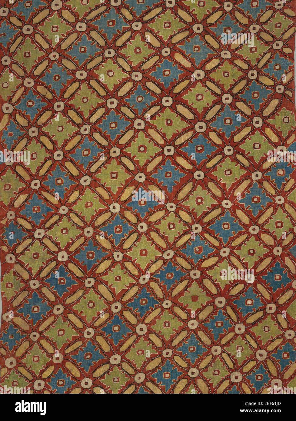 Panel. On a loosely woven red tabby ground, blue, pale green, white and buff silks in bukhara couching stitch form an all-over diagonal trellis pattern enclosing large diamond forms with leaf outlines in whose centers are reserved small squares. Stock Photo